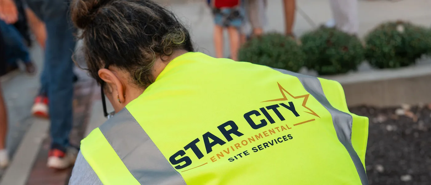 A Star City Environmental crew member working a public street during a community event.