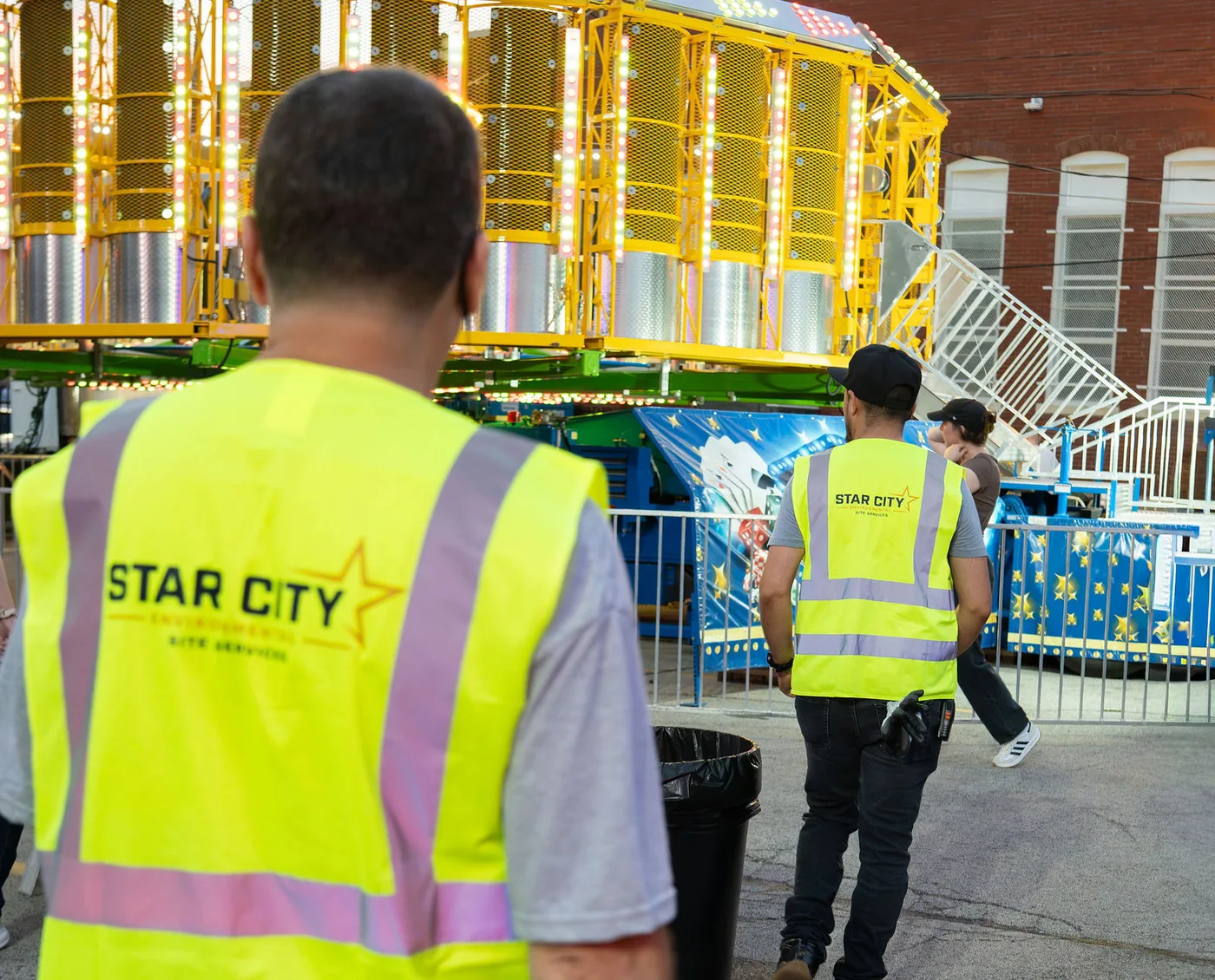 Two Star City Environmental crew members talking through the next collection round.