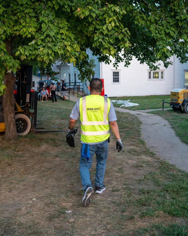 A crew member crossing grounds between collection points.